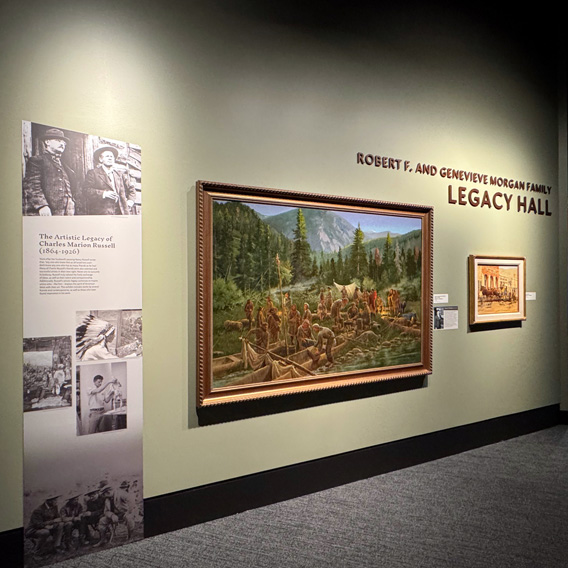 A sage green wall has a large painting and the text Robert F. and Genevieve Morgan Family Legacy Hall