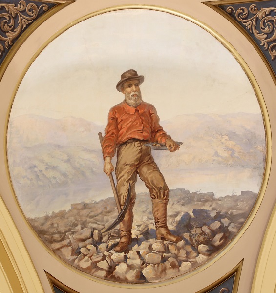 A painting of a prospector at Alder Gulch, holding a pick-ax and pan.